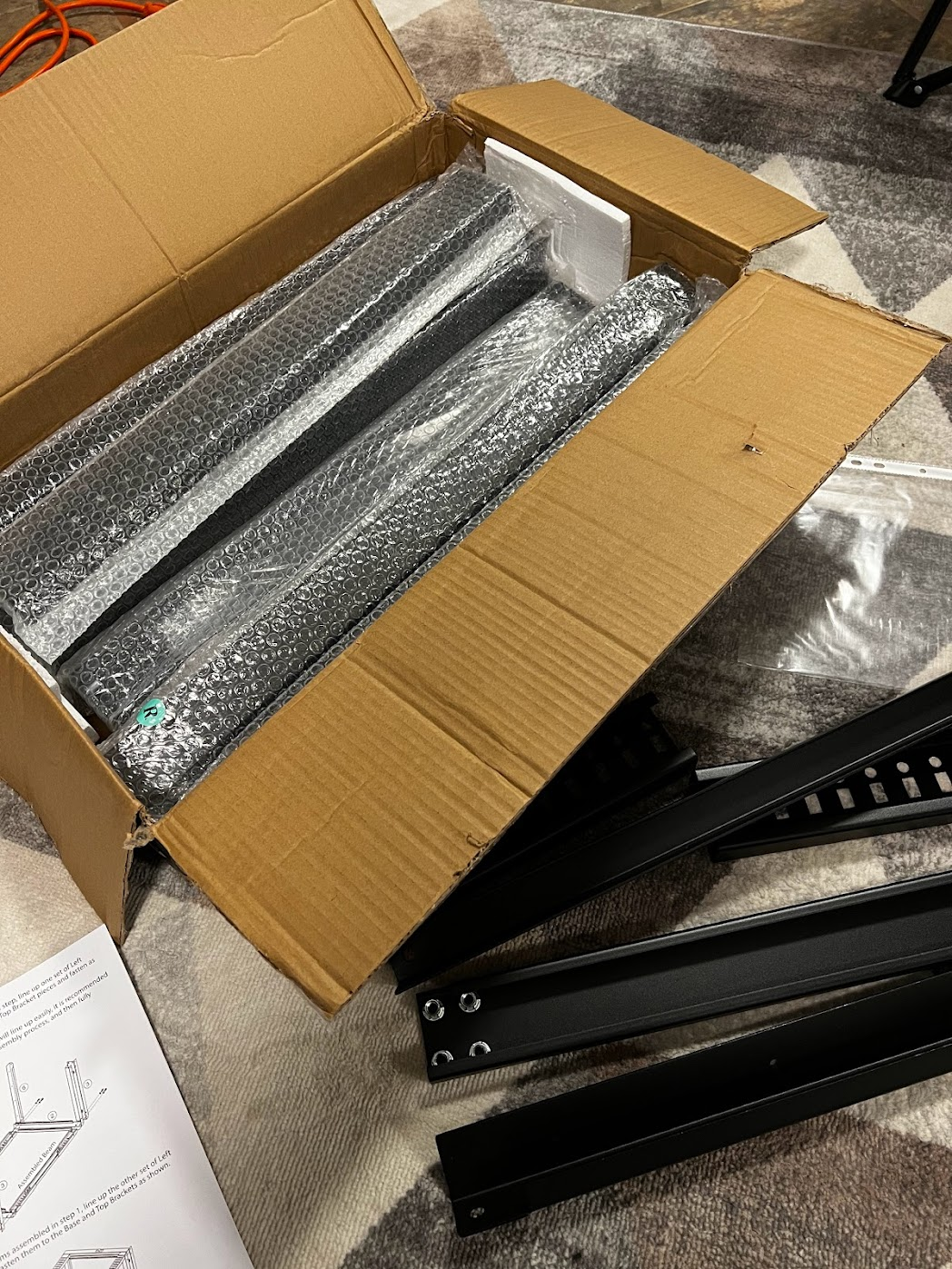 Amazon box containing all the metal pieces for the server rack